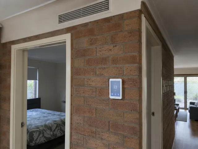 Brick interior wall with wall controller and ceiling return grille in a home in Paralowie